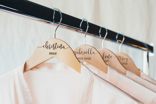 Bridesmaid wooden hangers with personalization engraved with the bridal parties custom names