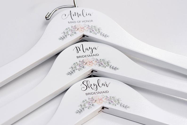 A Set of White Bridesmaid Printed Hanger with cream floral design